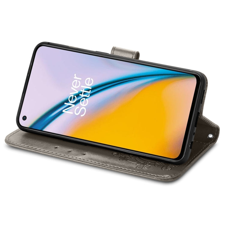 For OnePlus Nord 2 5G Four-leaf Clasp Embossed Buckle Mobile Phone Protection Leather Case with Lanyard & Card Slot & Wallet & Bracket Function