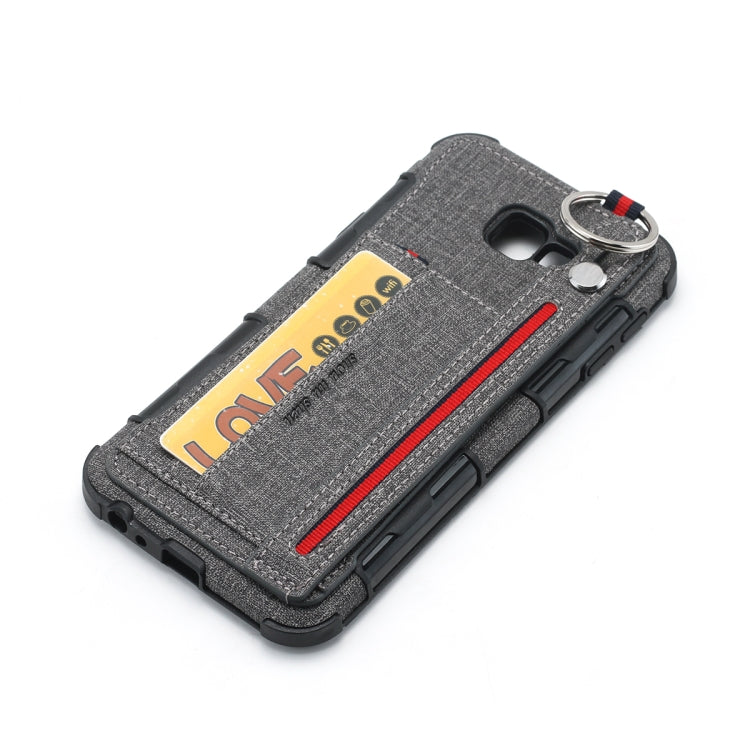For Galaxy J4+ Cloth Texture + TPU Shockproof Protective Case with Metal Ring & Holder & Card Slots & Hanging Strap