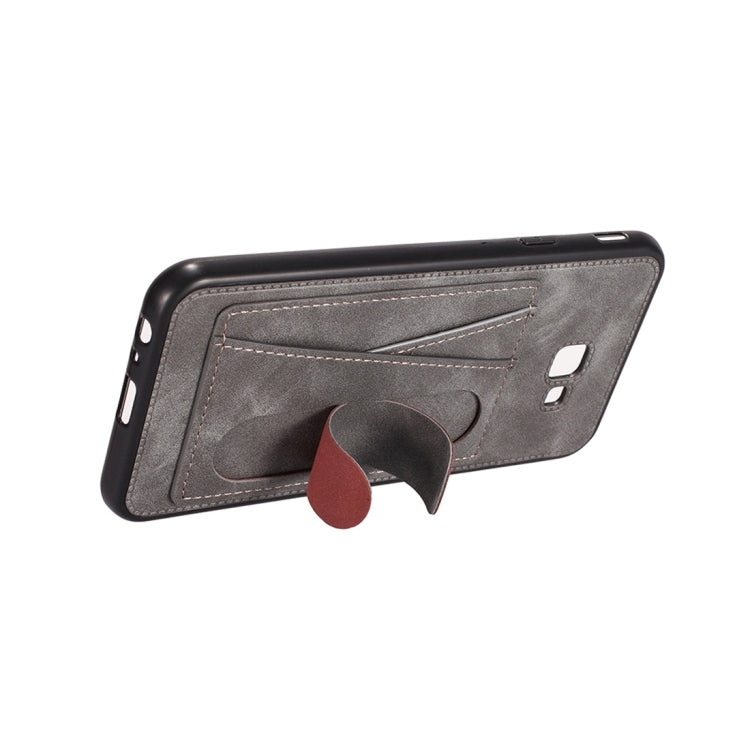 For Galaxy J4+ Shockproof PC + PU Protective Case with Spring Holder & Card Slot