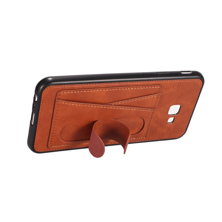 For Galaxy J4+ Shockproof PC + PU Protective Case with Spring Holder & Card Slot