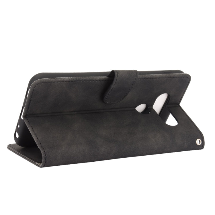 For LG Q70 Solid Color Skin Feel Magnetic Buckle Horizontal Flip Calf Texture PU Leather Case with Holder & Card Slots & Wallet