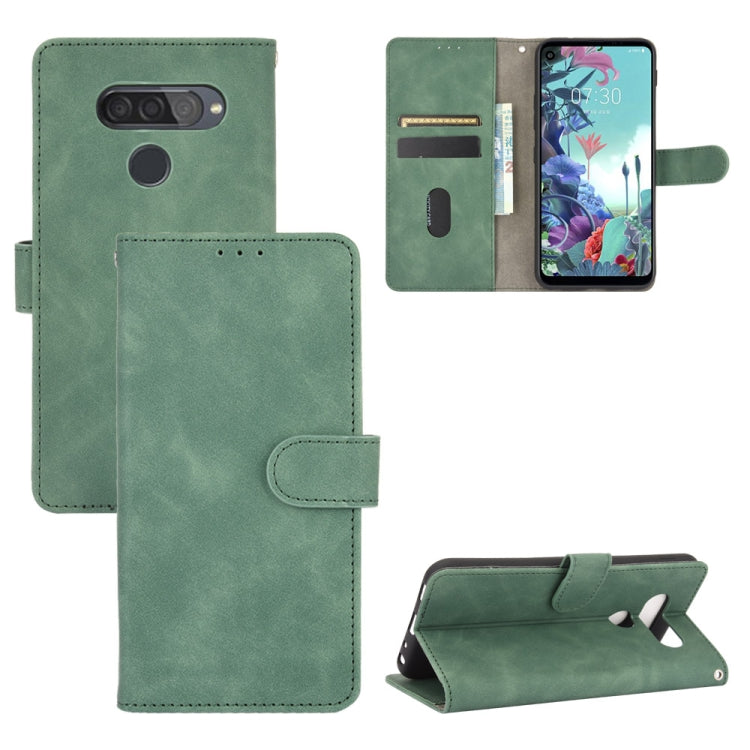 For LG Q70 Solid Color Skin Feel Magnetic Buckle Horizontal Flip Calf Texture PU Leather Case with Holder & Card Slots & Wallet