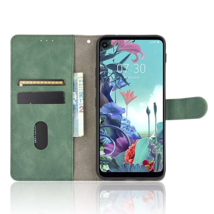 For LG Q70 Solid Color Skin Feel Magnetic Buckle Horizontal Flip Calf Texture PU Leather Case with Holder & Card Slots & Wallet