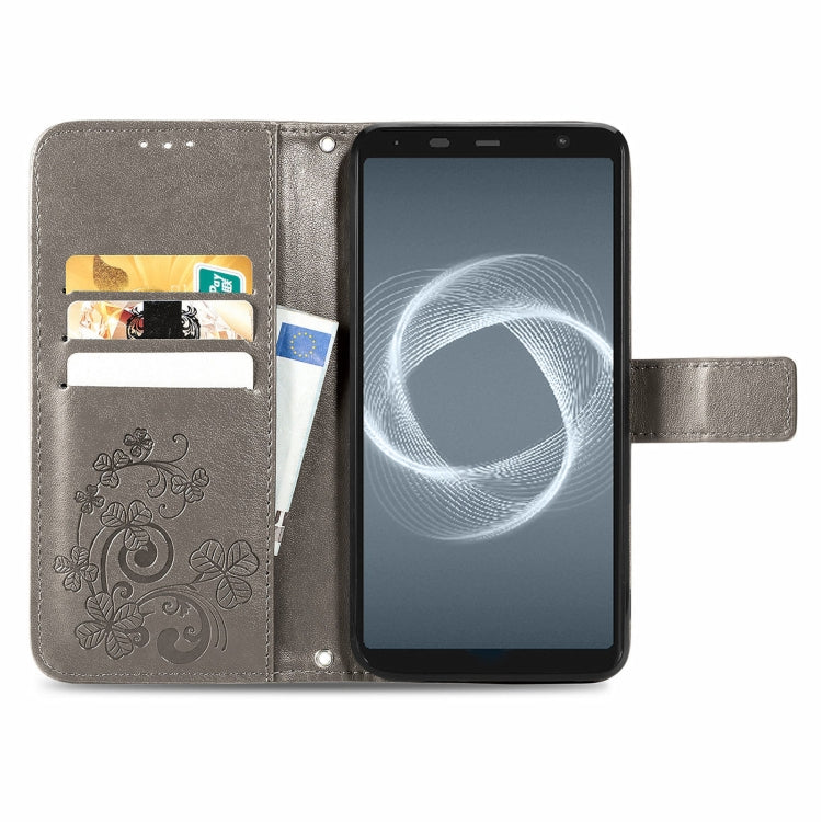 For FUJITSU F-41B Four-leaf Clasp Embossed Buckle Mobile Phone Protection Leather Case with Lanyard & Card Slot & Wallet & Bracket Function