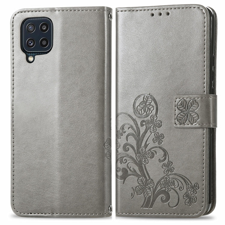 For Samsung Galaxy M32 Four-leaf Clasp Embossed Buckle Mobile Phone Protection Leather Case with Lanyard & Card Slot & Wallet & Bracket Function