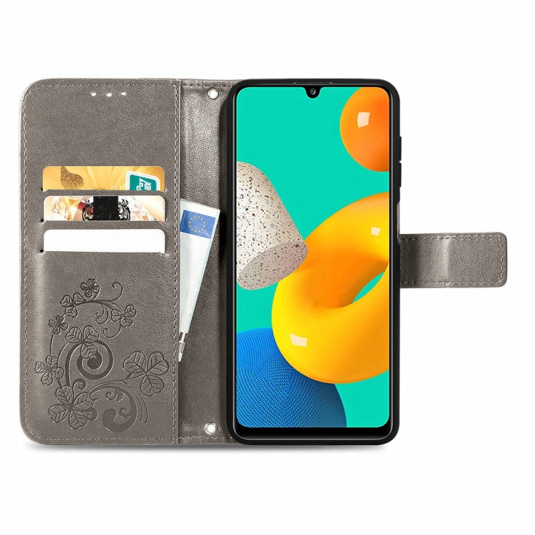 For Samsung Galaxy M32 Four-leaf Clasp Embossed Buckle Mobile Phone Protection Leather Case with Lanyard & Card Slot & Wallet & Bracket Function