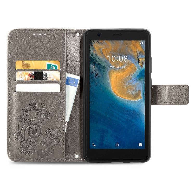 For ZTE Blade A31 Lite Four-leaf Clasp Embossed Leather Case with Lanyard & Card Slot & Wallet & Holder