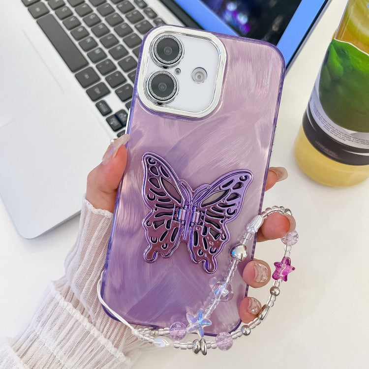For iPhone 16 Plating Glitter Lens Film Texture Butterfly Holder Wristband Phone Case