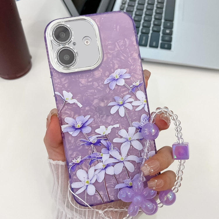 For iPhone 16 Plus Electroplating Flowers Plants Texture Wristband TPU Phone Case