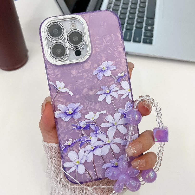 For iPhone 15 Pro Electroplating Flowers Plants Texture Wristband TPU Phone Case