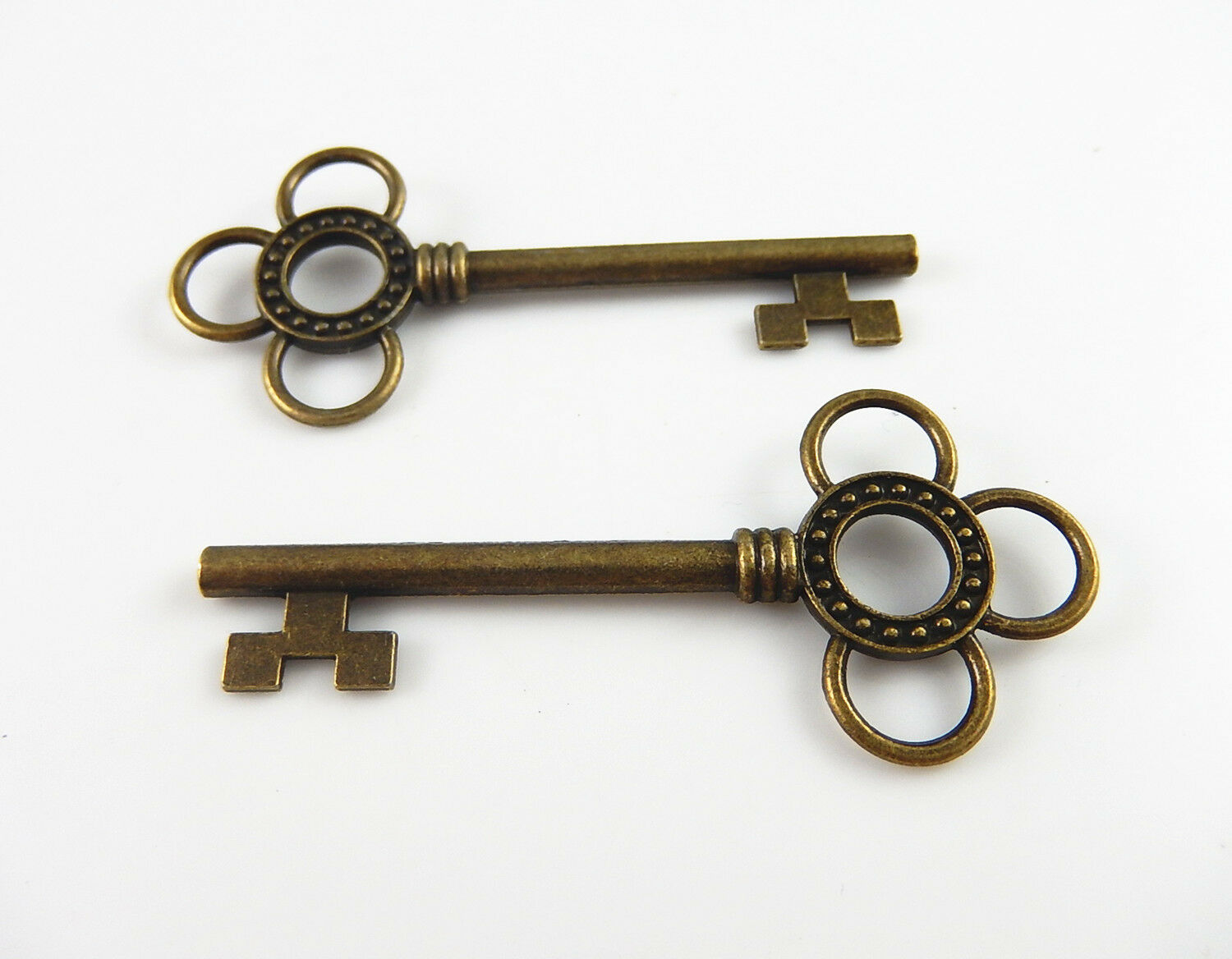 Lot of (x10) Antiqued Bronze Alloy Key Shaped Hollowed Flower Pendant 62x27 MM