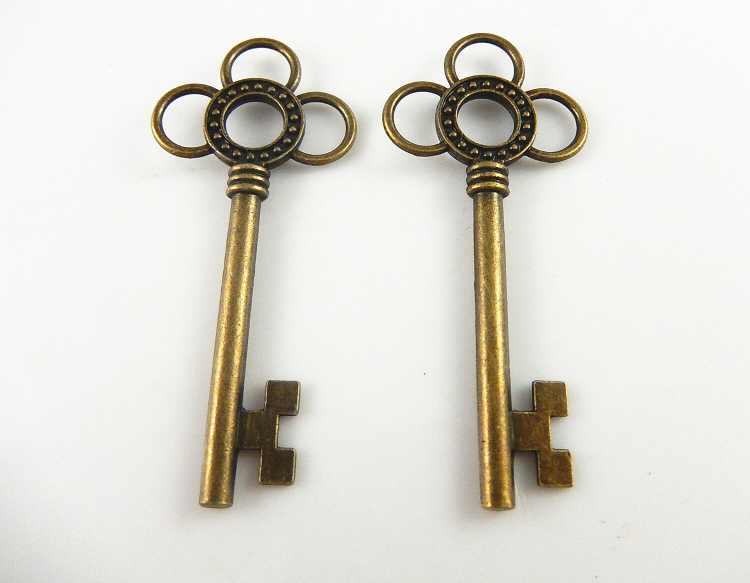Lot of (x10) Antiqued Bronze Alloy Key Shaped Hollowed Flower Pendant 62x27 MM